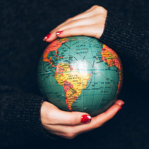 Woman's hands holding Earth. Over 360 Million People with Hearing Loss Worldwide
